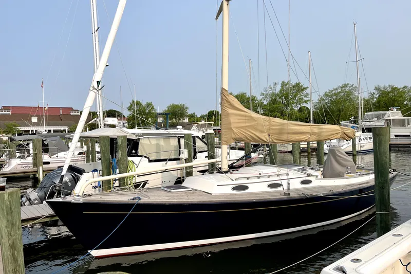  Yacht Photos Pics 2006 Alerion Express 38 sailboat docked at a marina, surrounded by other boats.