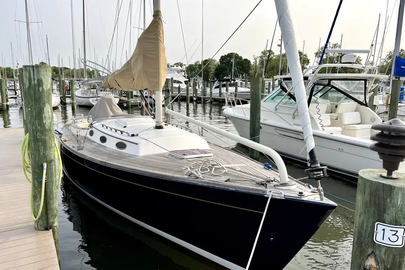  Yacht Photos Pics 2006 Alerion Express 38 sailboat docked at a marina, featuring sleek design and wooden deck.