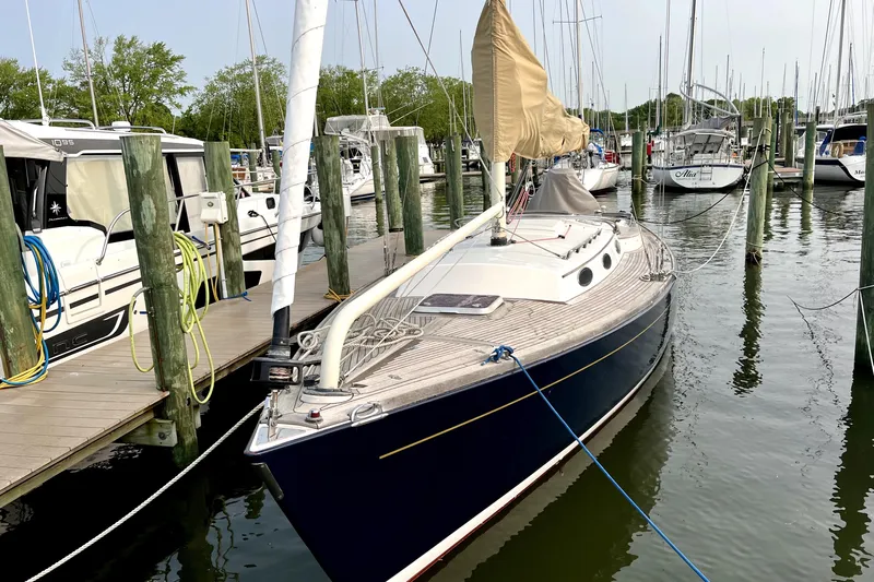  Yacht Photos Pics Alerion Express 38 sailboat, 2006 model, docked at a marina with other boats.