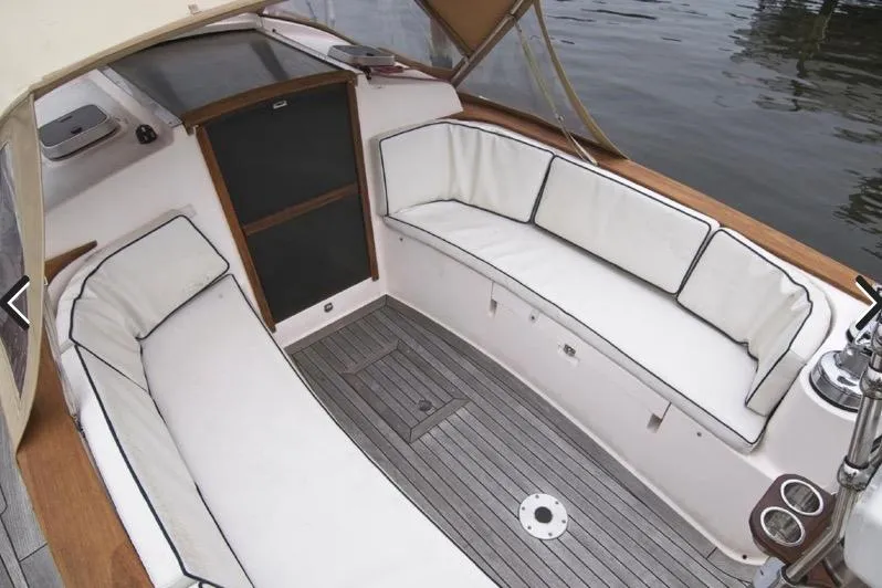  Yacht Photos Pics 2006 Alerion Express 38 sailboat cockpit with cushioned seating and teak flooring.