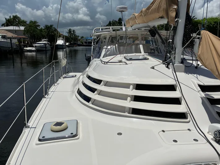 Bel Tempo Yacht Photos Pics 2008 Manta 42 MkIV catamaran docked in a serene marina setting.