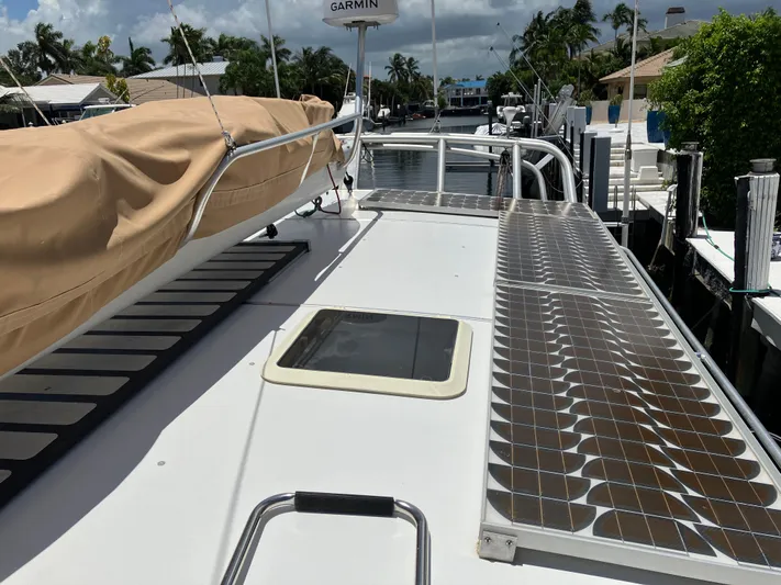 Bel Tempo Yacht Photos Pics 2008 Manta 42 MkIV catamaran deck with solar panels and covered sail.