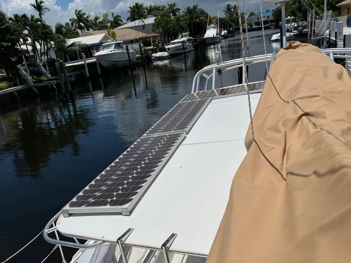 Bel Tempo Yacht Photos Pics 2008 Manta 42 MkIV catamaran with solar panels docked in a marina.