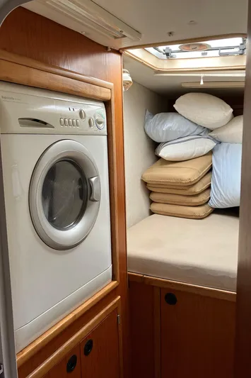 Bel Tempo Yacht Photos Pics Laundry area in 2008 Manta 42 MkIV yacht with washer and stacked cushions.