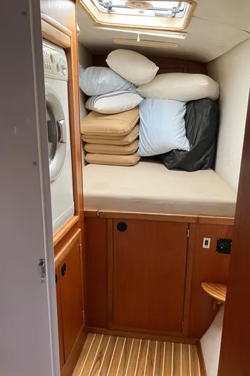 Bel Tempo Yacht Photos Pics Laundry area with stacked cushions in 2008 Manta 42 MkIV yacht.