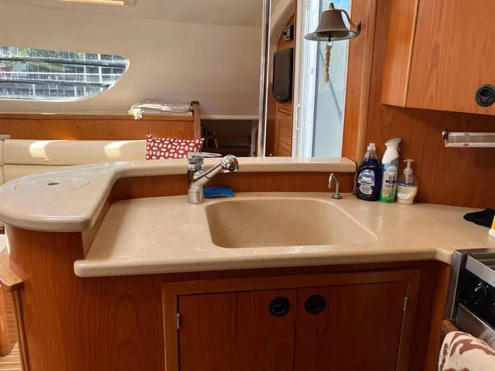 Bel Tempo Yacht Photos Pics Interior of 2008 Manta 42 MkIV yacht with kitchen sink and wooden cabinetry.