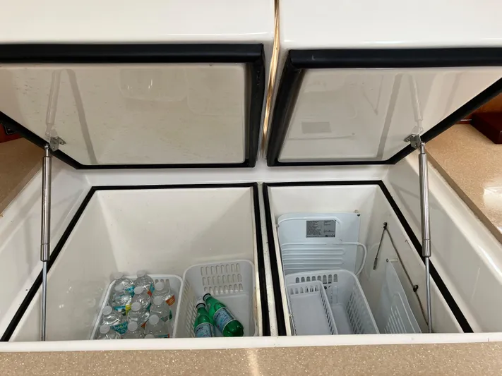 Bel Tempo Yacht Photos Pics Open storage compartments on 2008 Manta 42 MkIV yacht with beverages inside.