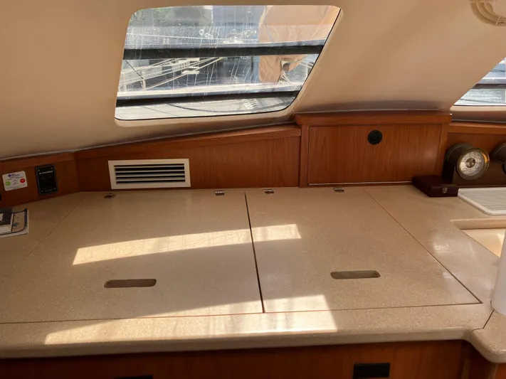 Bel Tempo Yacht Photos Pics Interior of 2008 Manta 42 MkIV yacht with wooden cabinetry and countertop.