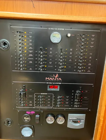 Bel Tempo Yacht Photos Pics Electrical panel of 2008 Manta 42 MkIV sailboat, featuring control switches and gauges.