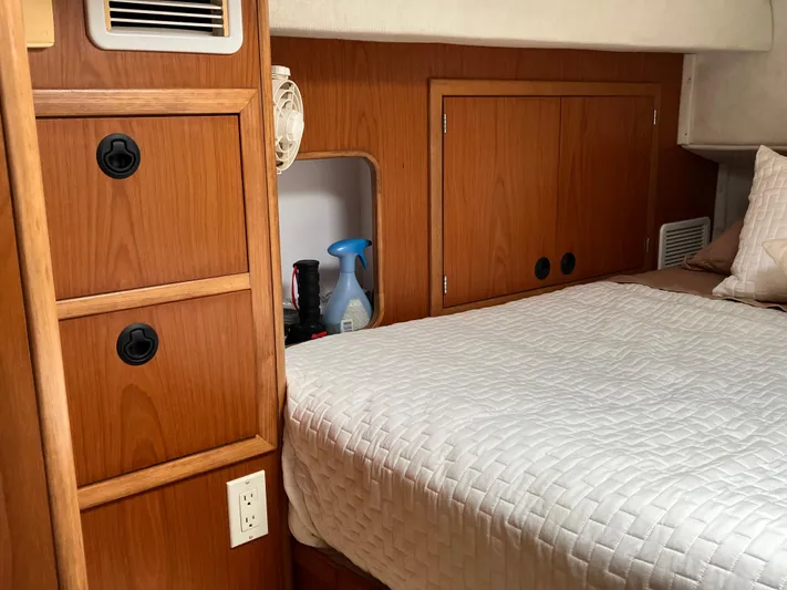 Bel Tempo Yacht Photos Pics Cozy cabin interior of 2008 Manta 42 MkIV with wooden storage and bed.