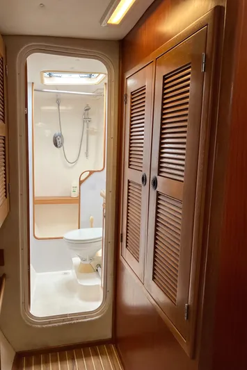 Bel Tempo Yacht Photos Pics 2008 Manta 42 MkIV yacht bathroom with wooden cabinets and shower.