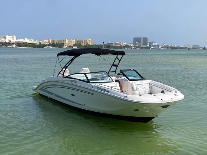 2015 Sea Ray 290 Sundeck Yacht Photos Pics 2015 Sea Ray 290 Sundeck boat on calm water with cityscape background.