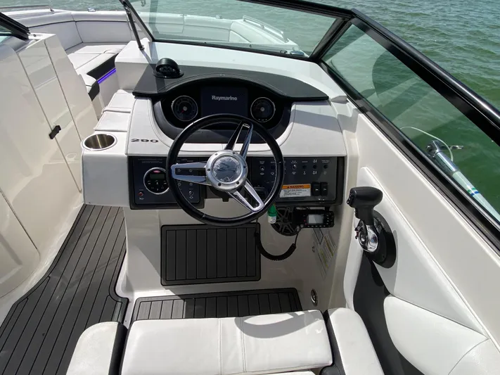 2015 Sea Ray 290 Sundeck Yacht Photos Pics 2015 Sea Ray 290 Sundeck helm with steering wheel and control panel on water.