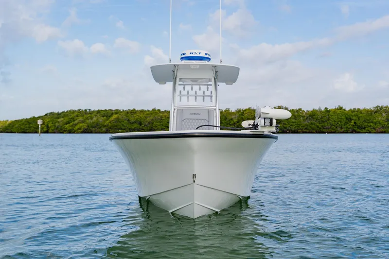  Yacht Photos Pics 2024 Orion 29CC boat on calm water with clear sky background.