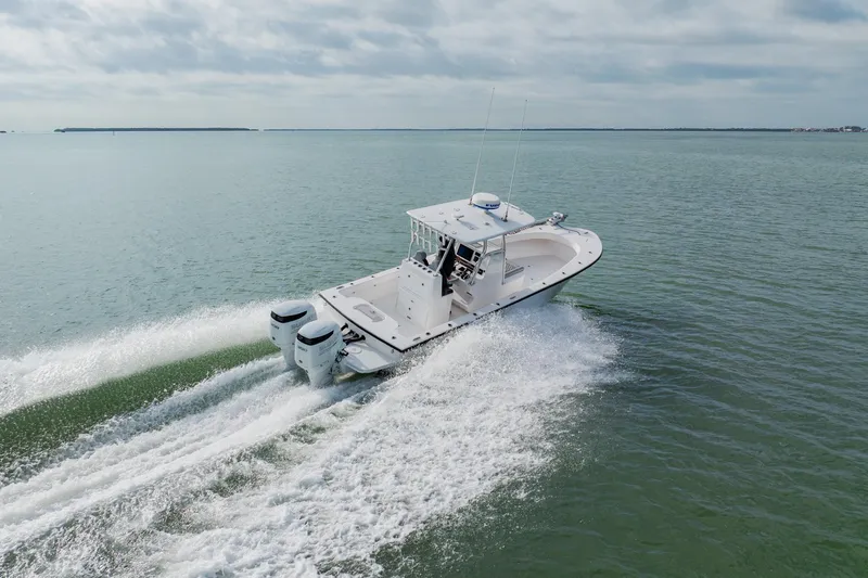  Yacht Photos Pics 2024 Orion 29CC boat cruising on open water, showcasing twin engines and sleek design.