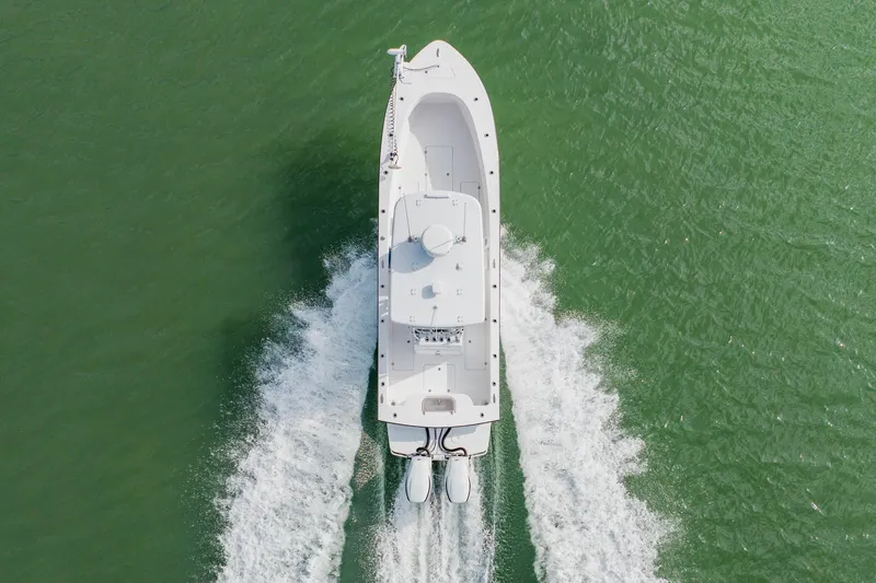  Yacht Photos Pics Aerial view of 2024 Orion 29CC boat cruising on green water.