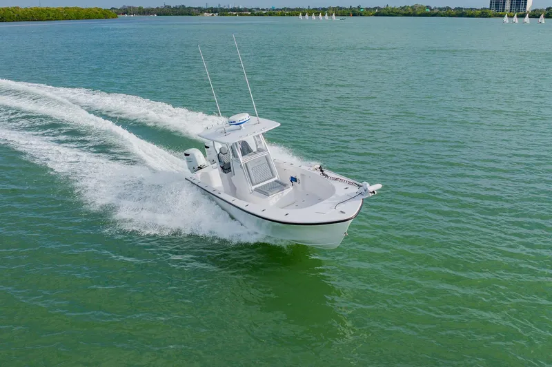  Yacht Photos Pics 2024 Orion 29CC boat cruising on open water, creating a dynamic wake.