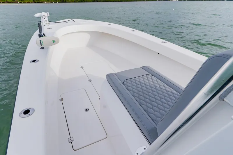  Yacht Photos Pics 2024 Orion 29CC boat interior with cushioned seating and storage compartments on the water.