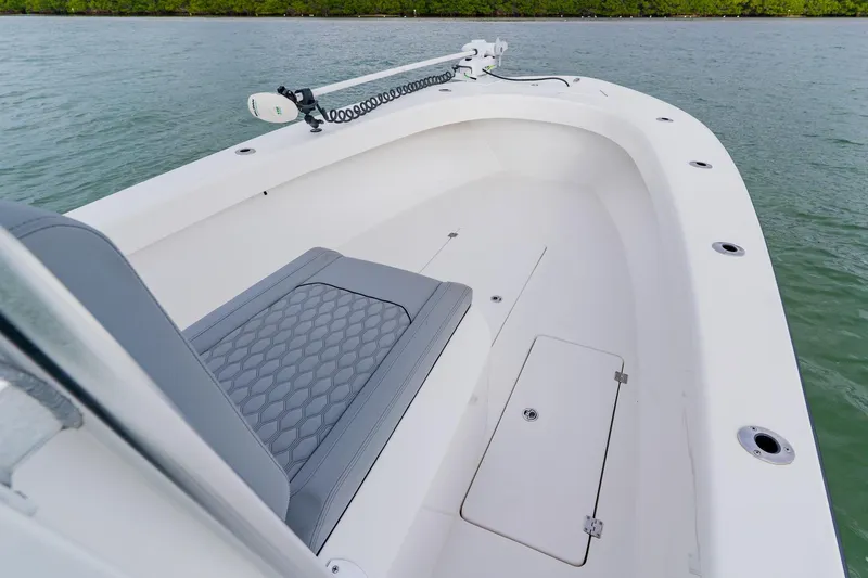  Yacht Photos Pics 2024 Orion 29CC boat interior with seating and storage, on calm water.