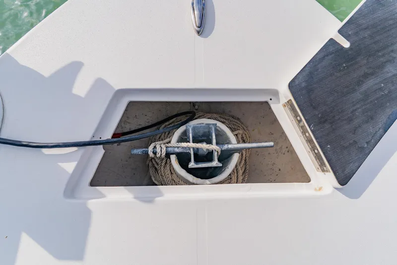  Yacht Photos Pics Anchor storage compartment on 2024 Orion 29CC boat, featuring coiled rope and anchor.