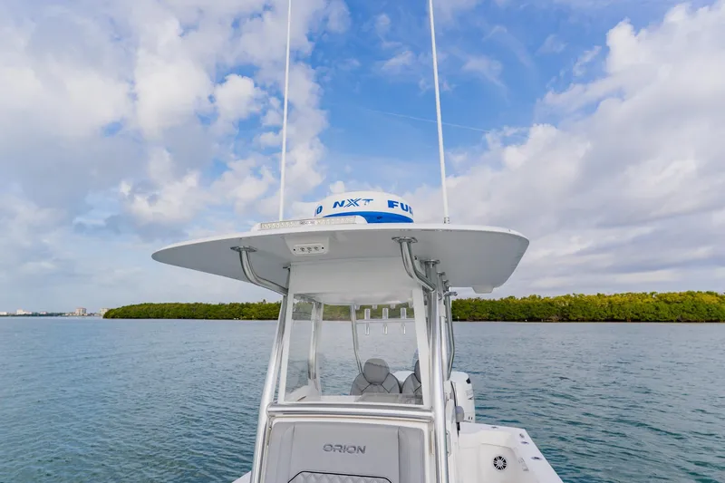  Yacht Photos Pics 2024 Orion 29CC boat on water under a partly cloudy sky.