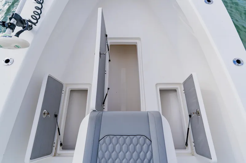  Yacht Photos Pics 2024 Orion 29CC boat interior with open storage compartments and seating.