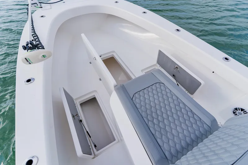  Yacht Photos Pics 2024 Orion 29CC boat interior with open storage compartments on calm water.