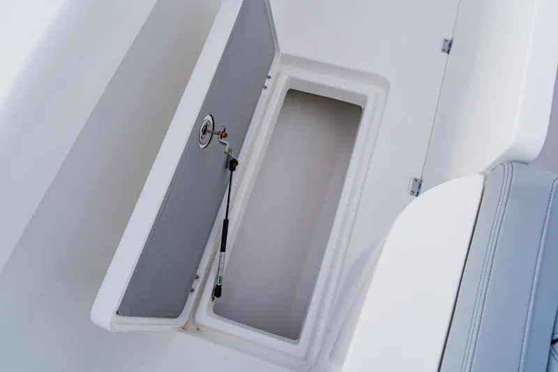  Yacht Photos Pics Open storage compartment on 2024 Orion 29CC boat, featuring a secure latch and hydraulic support.