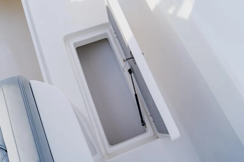  Yacht Photos Pics Open storage compartment on 2024 Orion 29CC boat, featuring hydraulic lift support.