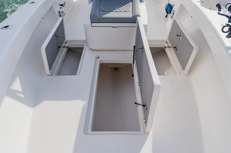  Yacht Photos Pics 2024 Orion 29CC boat interior with open storage compartments and seating.