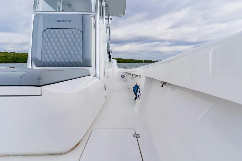  Yacht Photos Pics 2024 Orion 29CC boat interior with sleek seating and modern design on a calm water backdrop.