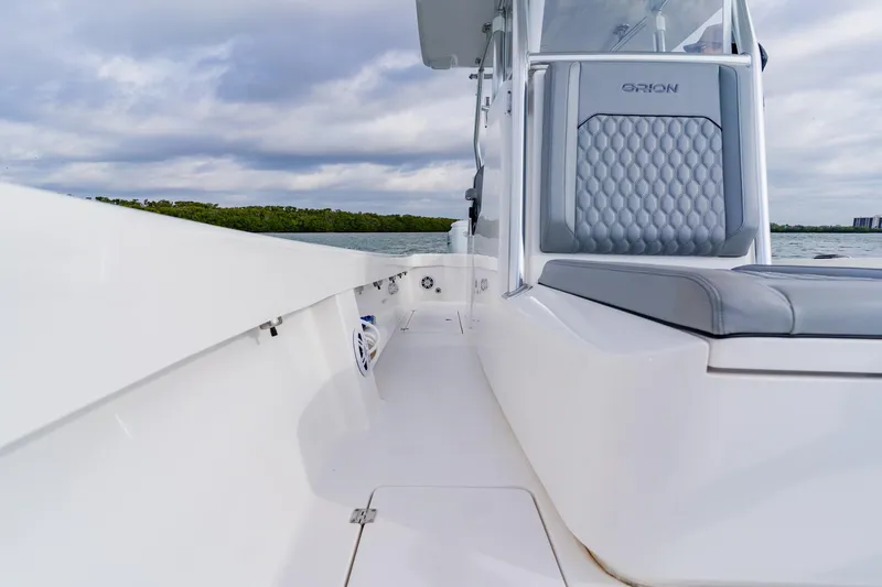  Yacht Photos Pics 2024 Orion 29CC boat interior with sleek seating and modern design on a calm water backdrop.