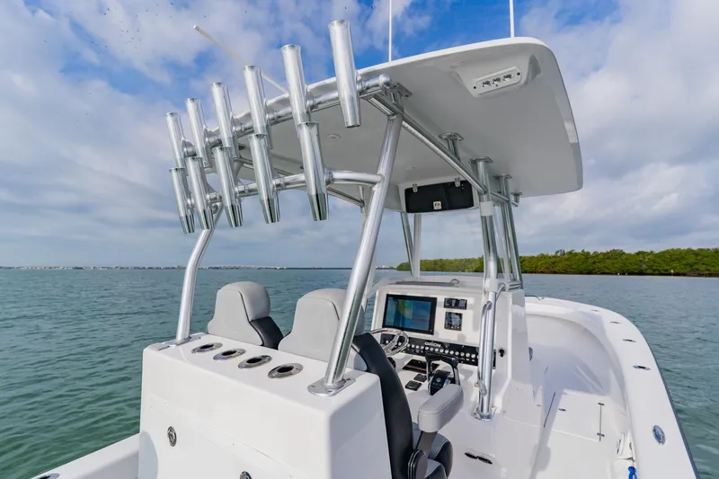  Yacht Photos Pics 2024 Orion 29CC boat interior with advanced navigation system and rod holders on open water.