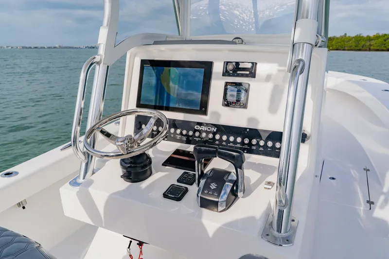  Yacht Photos Pics 2024 Orion 29CC boat dashboard with steering wheel and navigation controls.