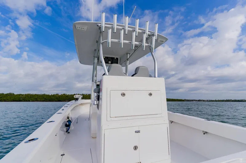  Yacht Photos Pics 2024 Orion 29CC boat on water, clear sky, and lush shoreline in background.