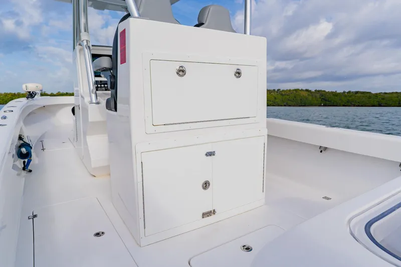  Yacht Photos Pics 2024 Orion 29CC boat interior with storage compartments, sleek design, and ocean backdrop.