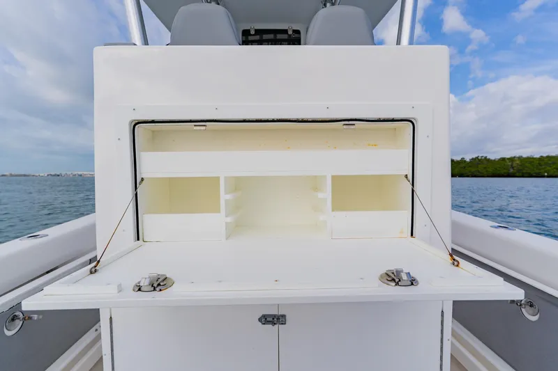  Yacht Photos Pics 2024 Orion 29CC boat storage compartment open on calm water.