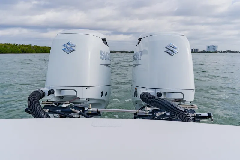  Yacht Photos Pics Twin Suzuki outboard motors on a 2024 Orion 29CC boat, cruising on open water.