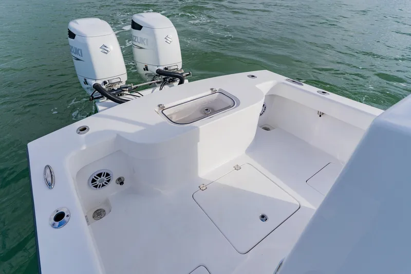  Yacht Photos Pics 2024 Orion 29CC boat with dual Suzuki outboard motors on calm water.