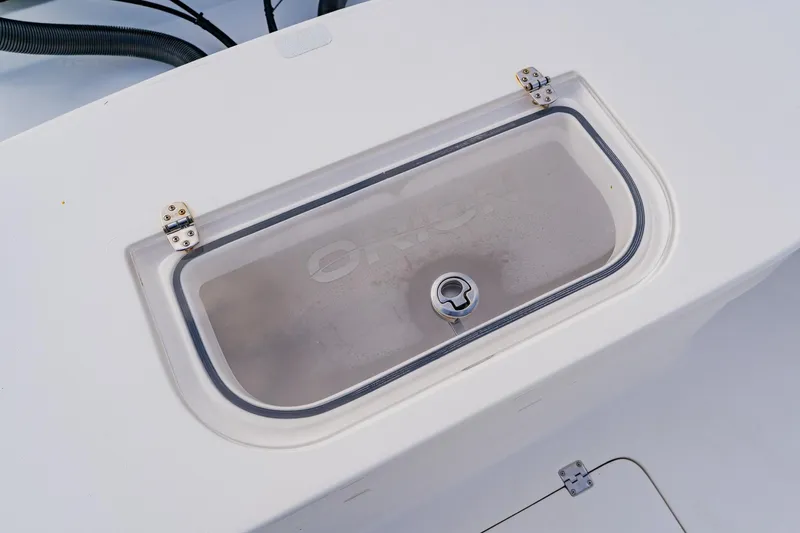  Yacht Photos Pics 2024 Orion 29CC boat compartment with secure latch and transparent cover.