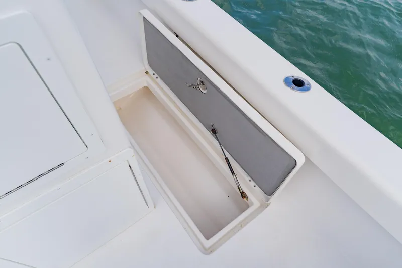  Yacht Photos Pics Open storage compartment on 2024 Orion 29CC boat, near water.