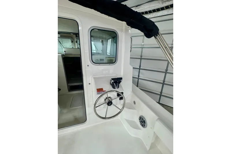  Yacht Photos Pics 2026 Parker 2520 XLD Sport Cabin interior with steering wheel and cabin door.