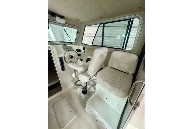  Yacht Photos Pics Interior of 2026 Parker 2520 XLD Sport Cabin with steering wheel and seating.