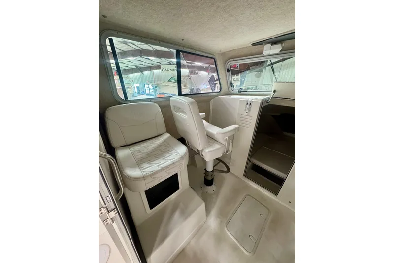  Yacht Photos Pics 2026 Parker 2520 XLD Sport Cabin interior with seating and helm, showcasing modern design.