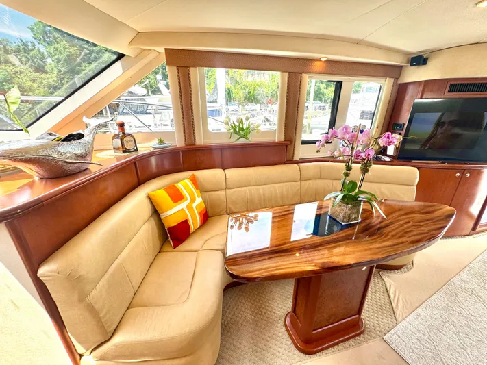 A Whole New World Yacht Photos Pics Luxurious interior of a 2006 Silverton 50 Convertible yacht with elegant seating and decor.