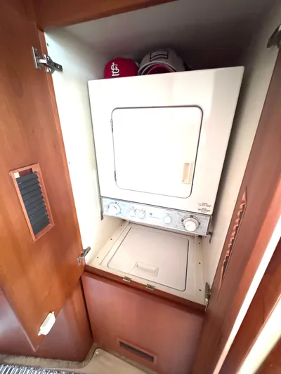A Whole New World Yacht Photos Pics Stacked washer and dryer in 2006 Silverton 50 Convertible yacht interior.