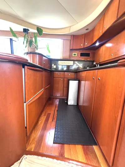 A Whole New World Yacht Photos Pics Interior of 2006 Silverton 50 Convertible yacht with wooden cabinetry and modern design.