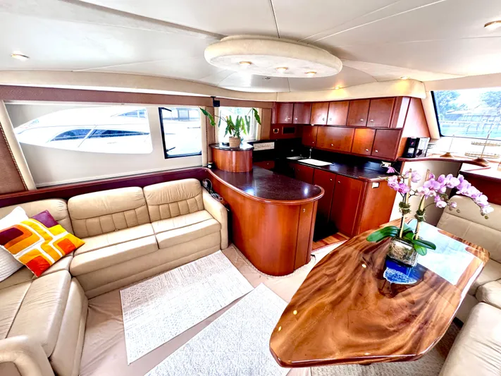 A Whole New World Yacht Photos Pics Luxurious interior of a 2006 Silverton 50 Convertible yacht with elegant wood finishes.