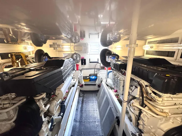 A Whole New World Yacht Photos Pics Engine room of a 2006 Silverton 50 Convertible yacht, featuring dual engines and clean layout.