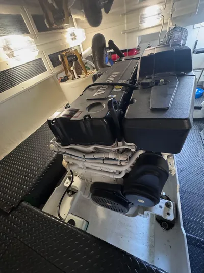 A Whole New World Yacht Photos Pics Engine room of 2006 Silverton 50 Convertible yacht, featuring a powerful engine setup.